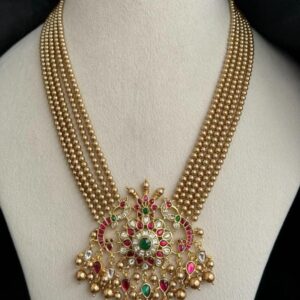 Gold plated multi-layer beaded necklace featuring a temple style pendant with green and red stones