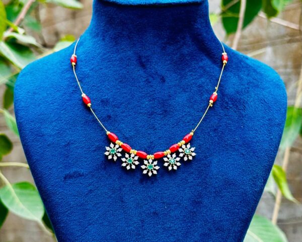 Red bead floral stone necklace featuring green center stones